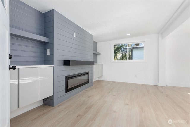 unfurnished living room with light hardwood / wood-style flooring