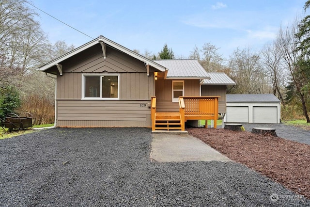 view of front of house featuring a wooden deck, an outbuilding, and a garage