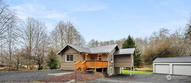 view of front of house with a garage and an outdoor structure