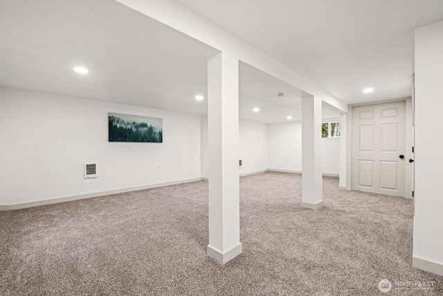 finished basement with carpet, visible vents, baseboards, and recessed lighting