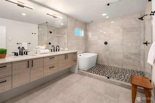 bathroom with tile patterned flooring, vanity, and separate shower and tub