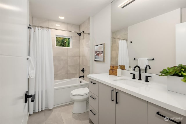 full bathroom featuring toilet, tile patterned floors, vanity, and shower / tub combo with curtain