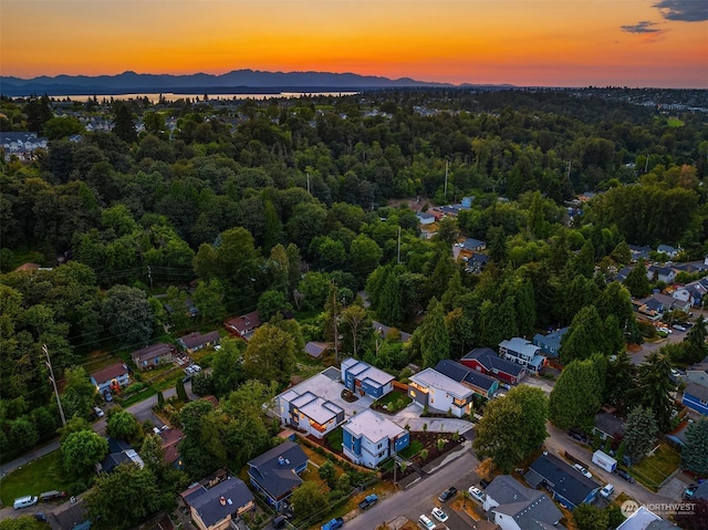 aerial view at dusk featuring a mountain view