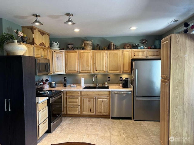 kitchen featuring appliances with stainless steel finishes, sink, and light tile patterned floors