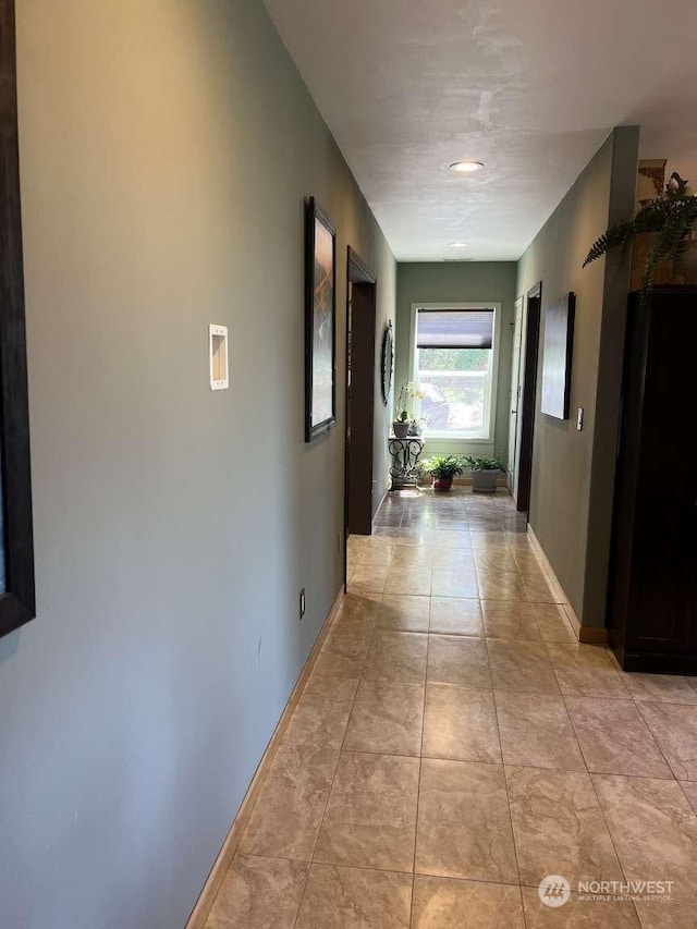 corridor with light tile patterned flooring