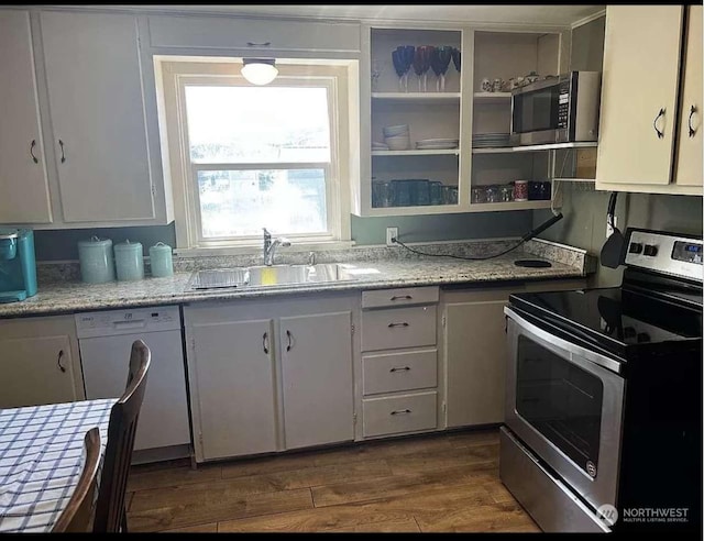 kitchen with white cabinetry, stainless steel appliances, dark hardwood / wood-style floors, and sink