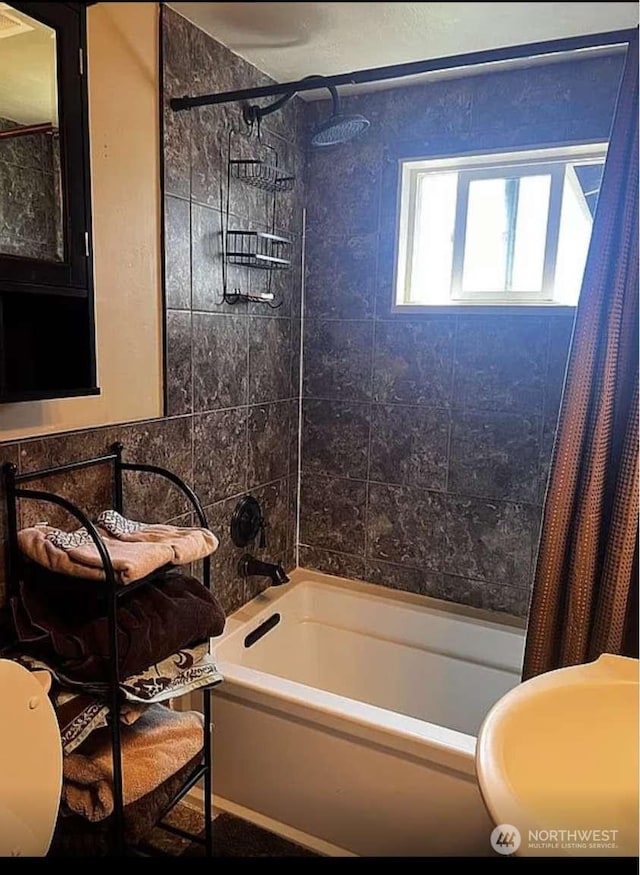 bathroom with shower / bathtub combination with curtain