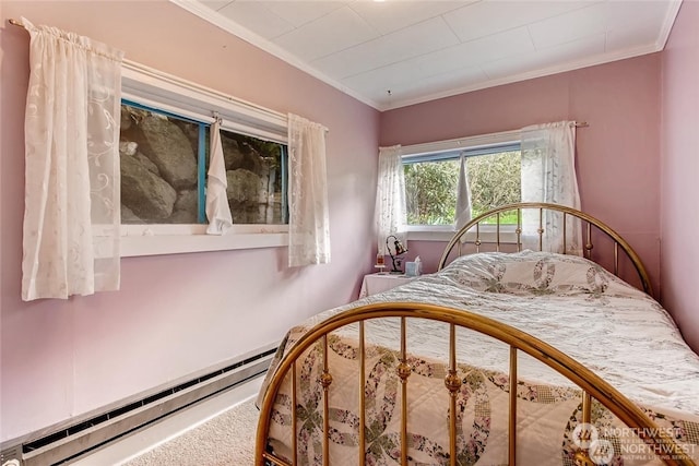 bedroom with baseboard heating, crown molding, and carpet