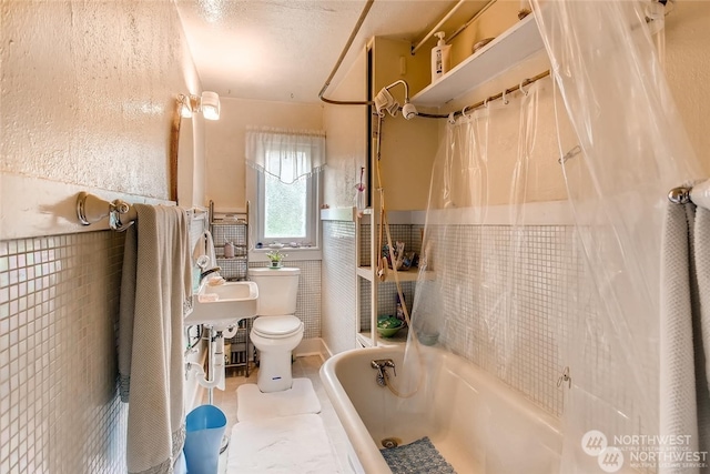 bathroom featuring shower / bath combination with curtain and toilet