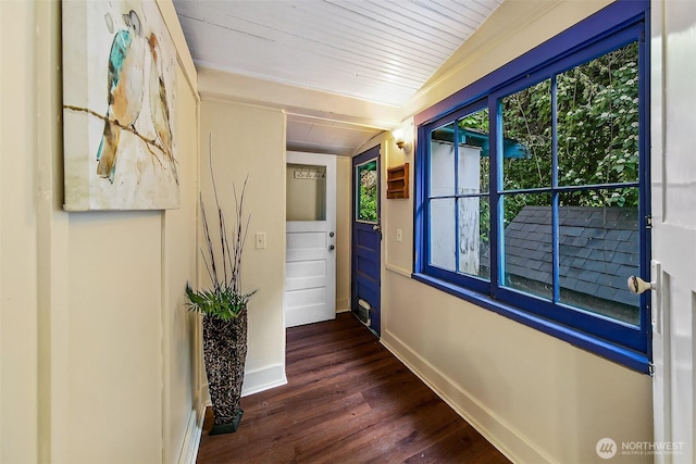 corridor with dark wood-style floors, wood ceiling, and baseboards