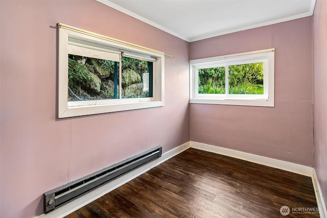 empty room featuring dark wood finished floors, baseboards, crown molding, and baseboard heating