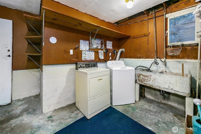 laundry area featuring laundry area, a sink, and washing machine and clothes dryer