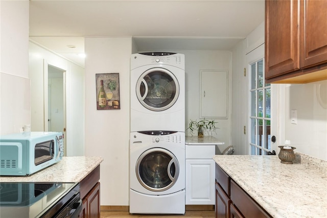 laundry area with stacked washer and clothes dryer