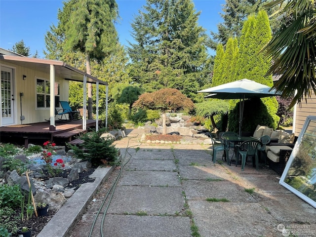 view of yard with a patio and a wooden deck