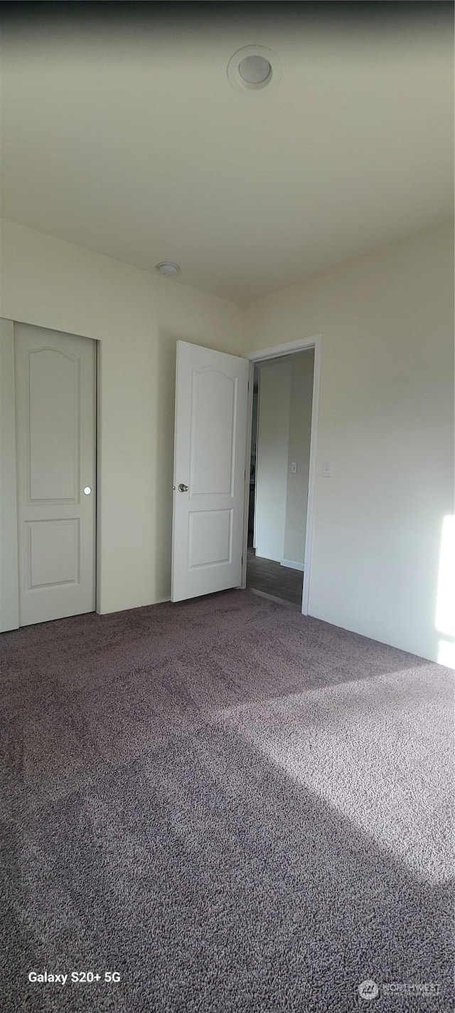 empty room with carpet flooring