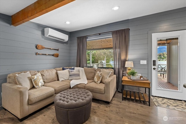 living room with an AC wall unit, wood walls, wood-type flooring, and beamed ceiling