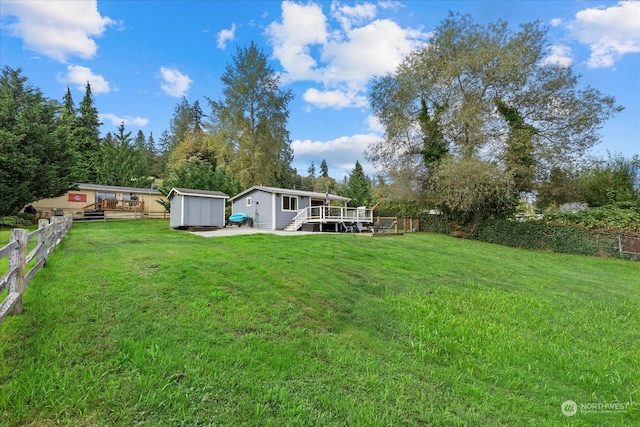 view of yard with a storage unit and a wooden deck