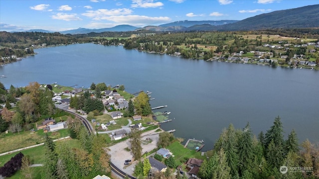 birds eye view of property with a water and mountain view