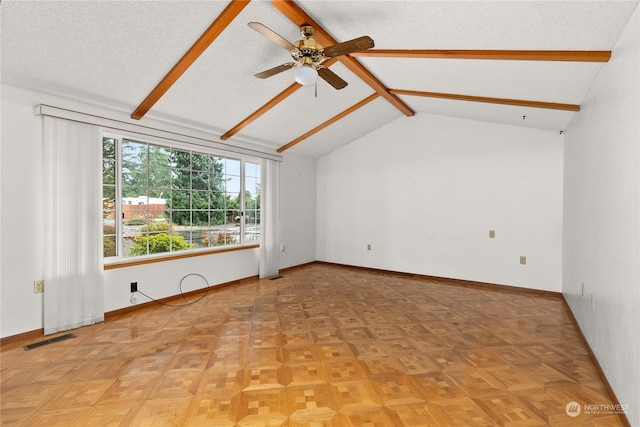 spare room with ceiling fan, lofted ceiling with beams, and a textured ceiling