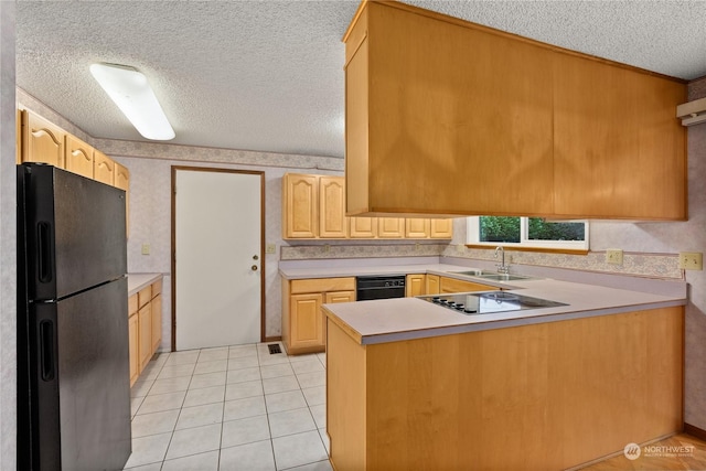 kitchen with black refrigerator, kitchen peninsula, sink, light brown cabinets, and electric cooktop