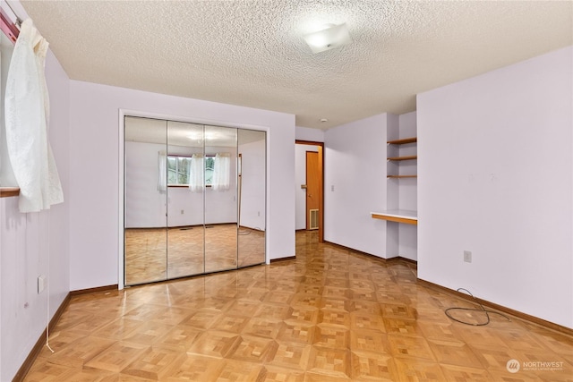 unfurnished bedroom featuring a closet and a textured ceiling