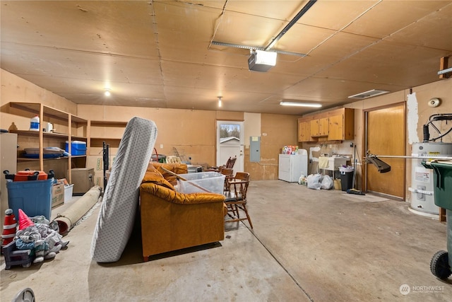 basement with secured water heater, independent washer and dryer, and electric panel