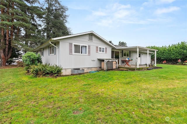 back of property with a yard and a patio