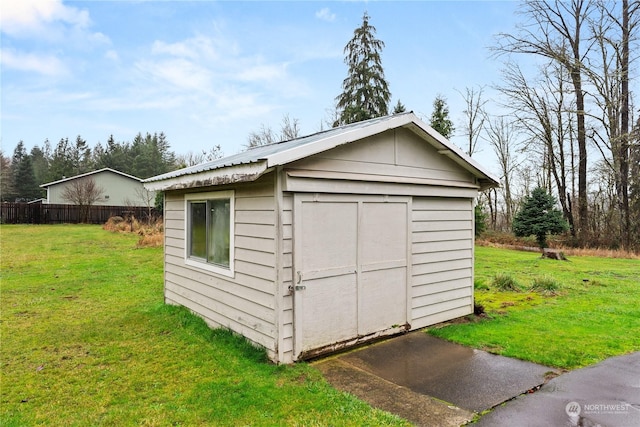 view of outdoor structure featuring a lawn