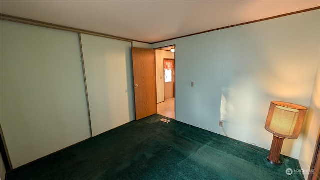 carpeted empty room featuring ornamental molding