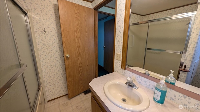 bathroom featuring crown molding and vanity