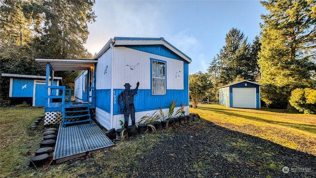 1902 322nd Pl, Ocean Park, WA 98640 - view of front of property featuring a garage, a front yard, and a storage unit