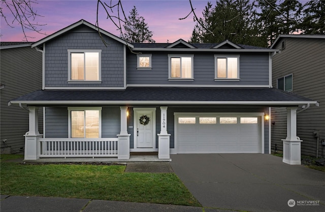 view of front of home featuring a garage and covered porch