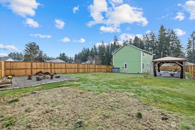 view of yard with a gazebo and a fire pit