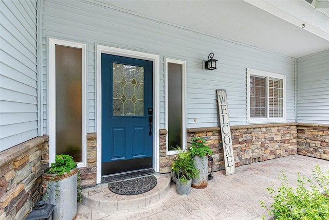 view of exterior entry featuring a porch