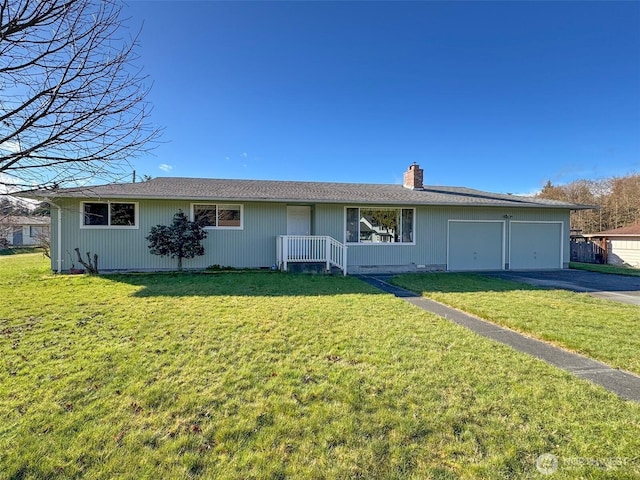 ranch-style house featuring a front yard, an attached garage, driveway, and a chimney