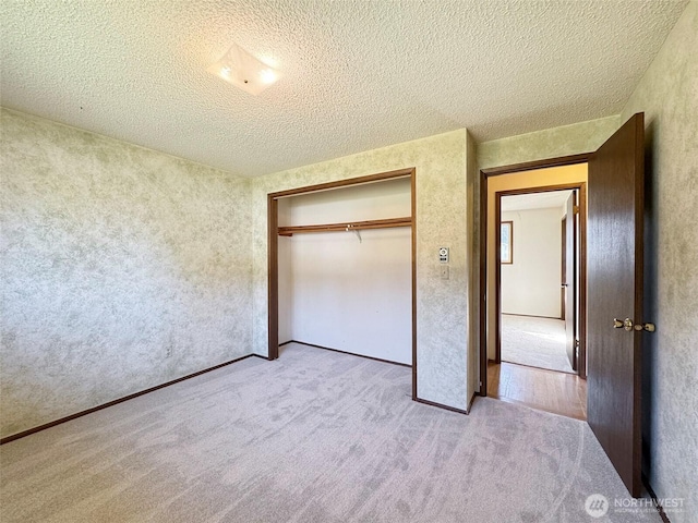 unfurnished bedroom with a closet, carpet floors, and a textured ceiling