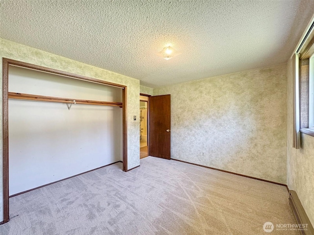 unfurnished bedroom featuring a textured ceiling, carpet, a closet, and a baseboard radiator