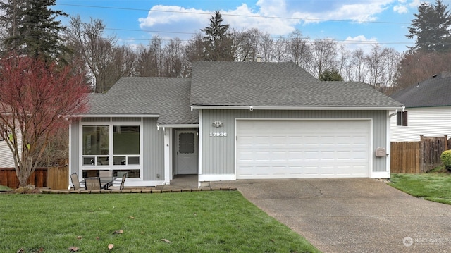 view of front of property with a front lawn and a garage