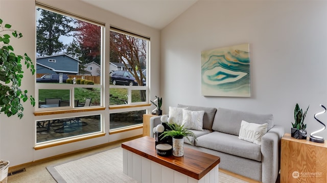 living room featuring vaulted ceiling and light carpet