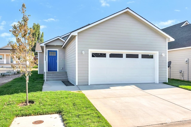 view of front of house featuring a garage and a front lawn