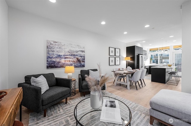 living room with light wood-type flooring and recessed lighting