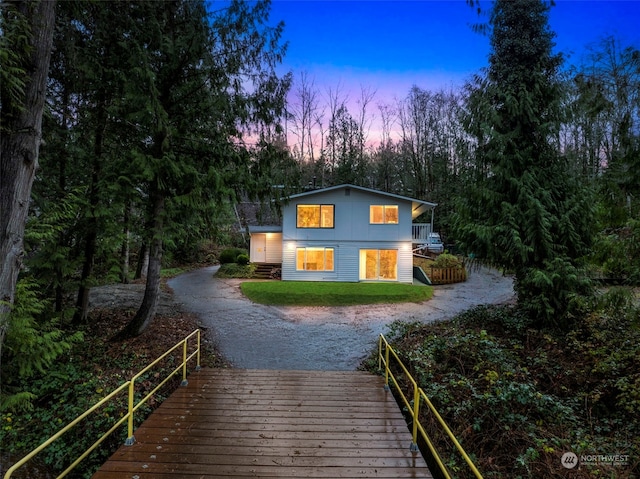 view of back house at dusk