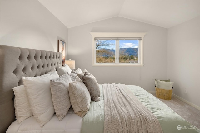 carpeted bedroom featuring lofted ceiling