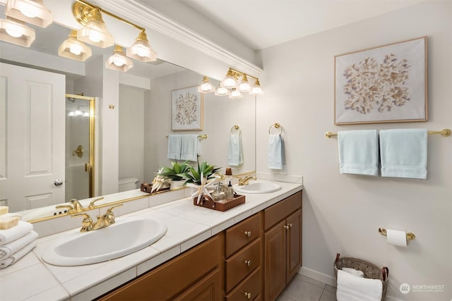 bathroom with tile patterned flooring, vanity, toilet, and a shower with shower door