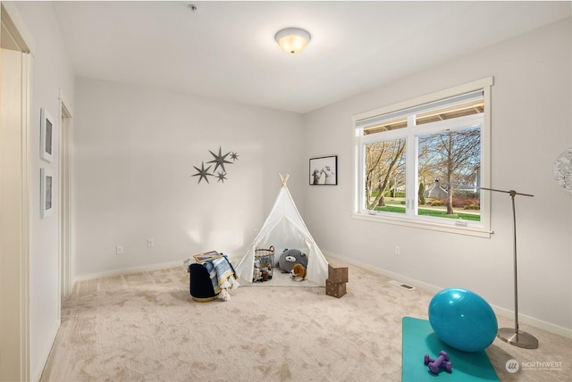 recreation room with light carpet