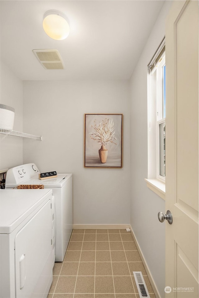 clothes washing area with washer and dryer