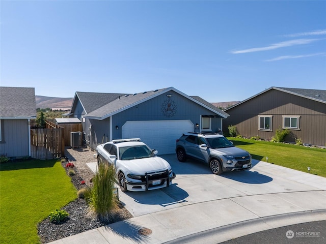 ranch-style home with a garage, central air condition unit, and a front yard