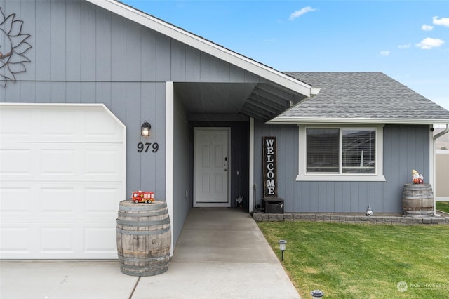 doorway to property featuring a lawn and a garage