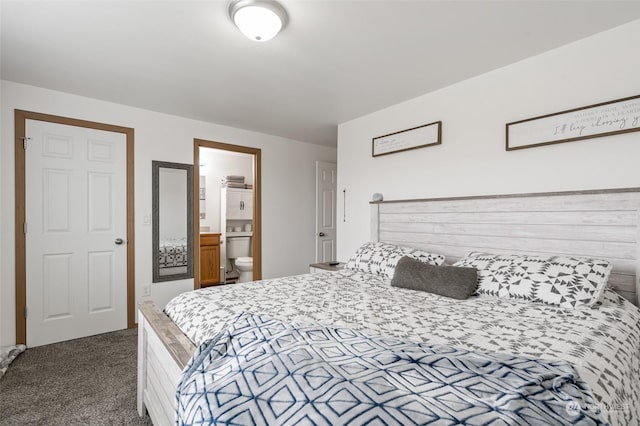 bedroom with ensuite bathroom and carpet flooring