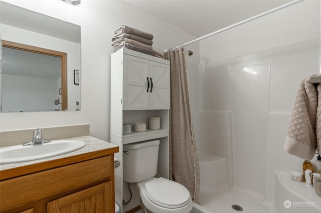 bathroom with a shower with shower curtain, vanity, and toilet